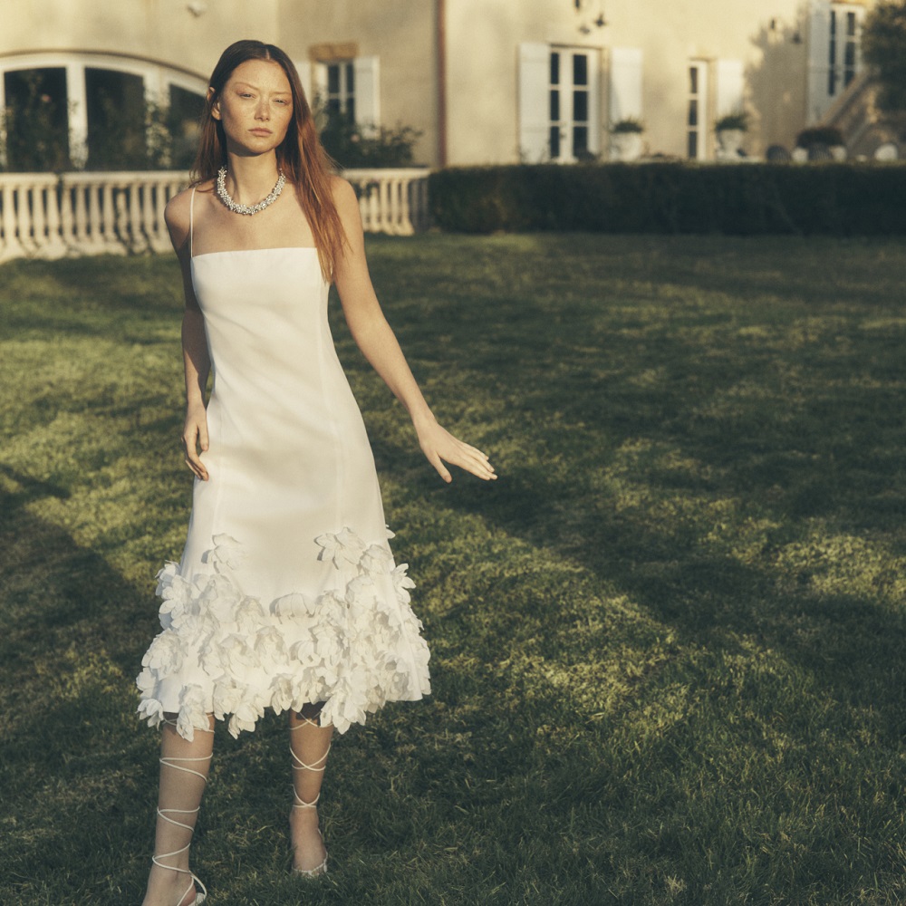 woman in a back yard wearing a white dress