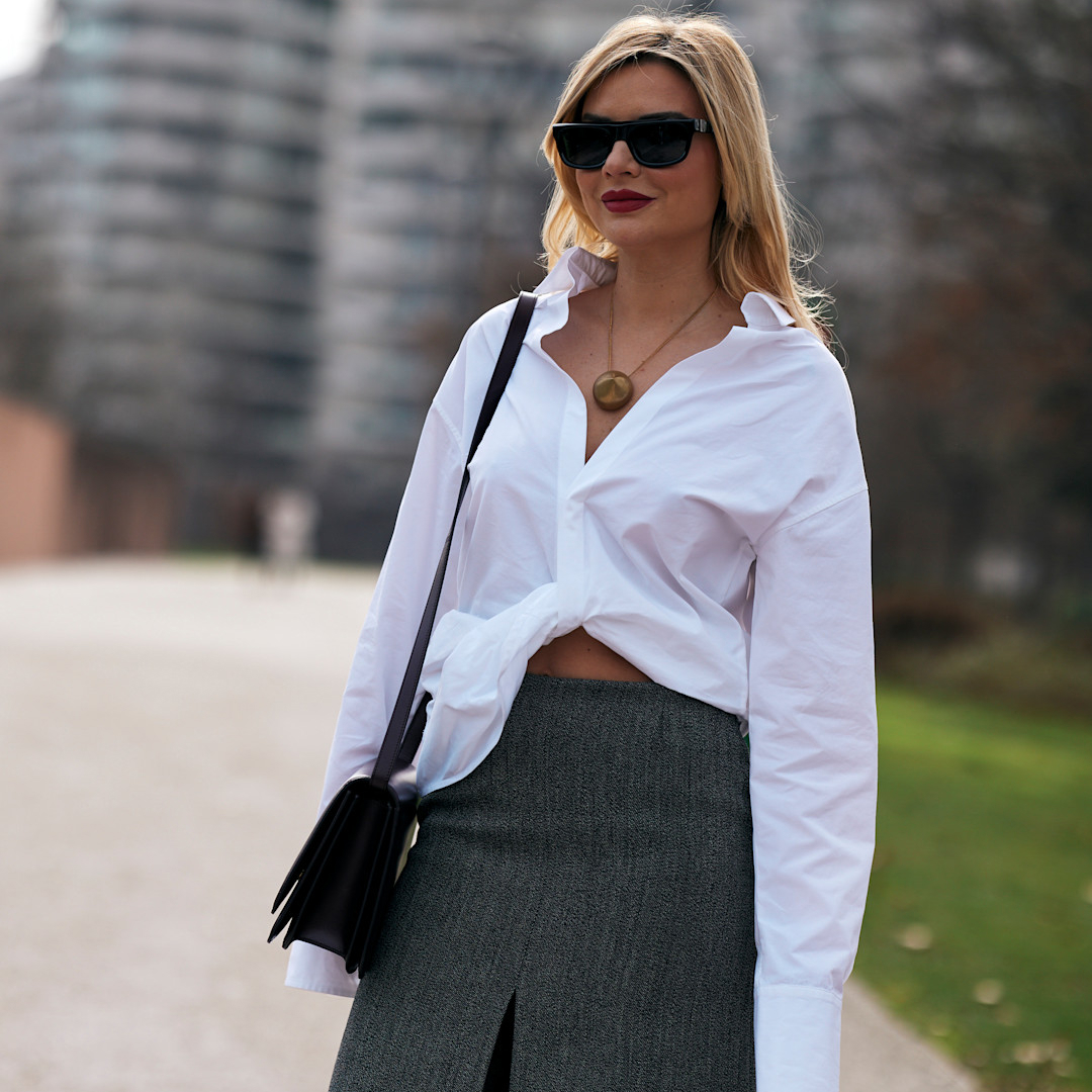 milan fashion week attendee wearing white blouse and black sunglasses 