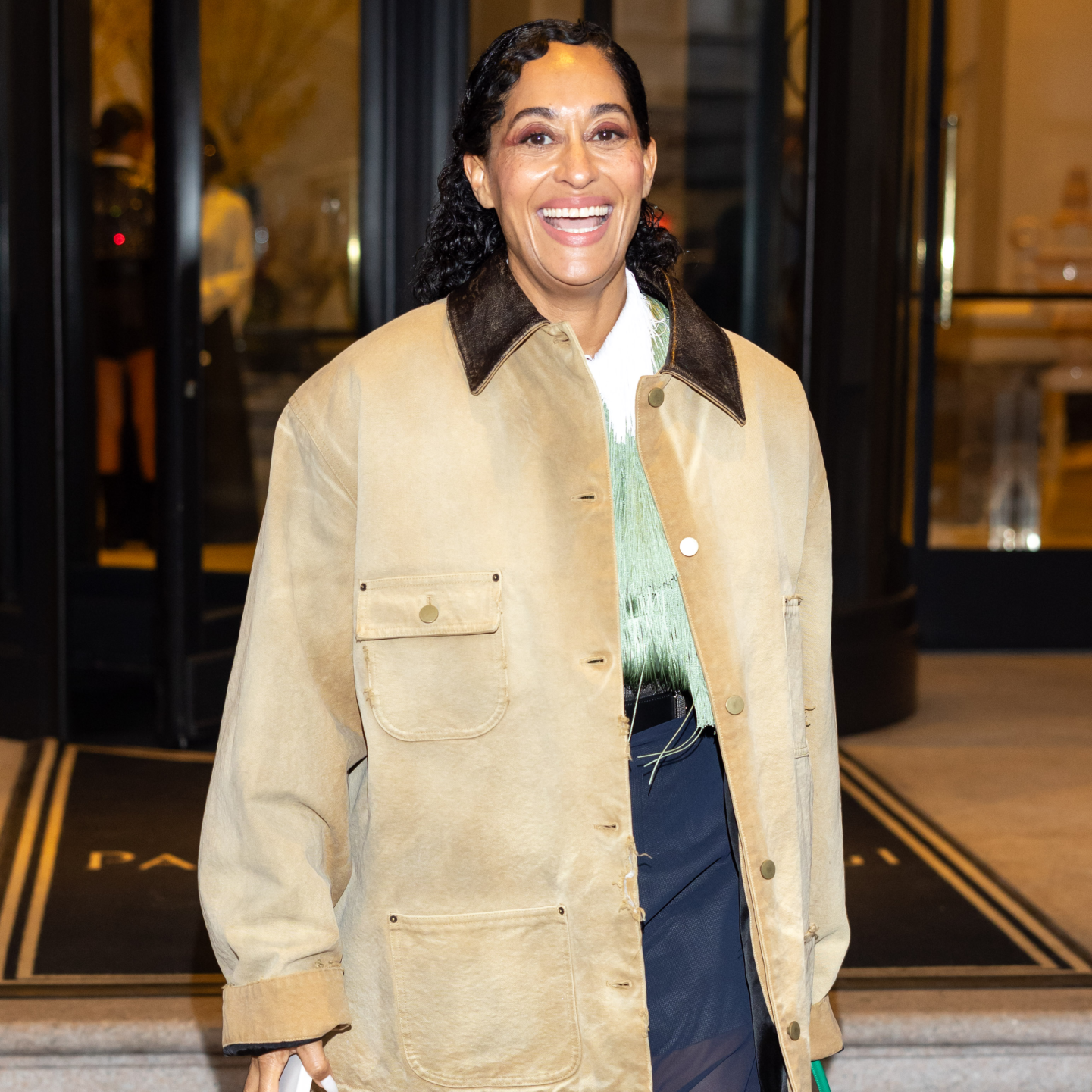 Tracee Ellis Ross in finger coils, a tan jacket and graphic eyeliner
